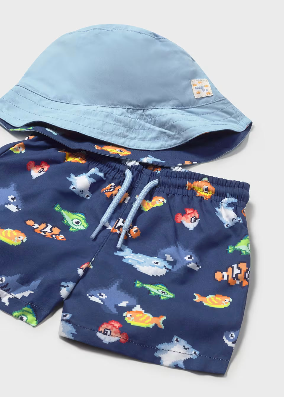 Conjunto bañador y gorro reversible protección solar bebé