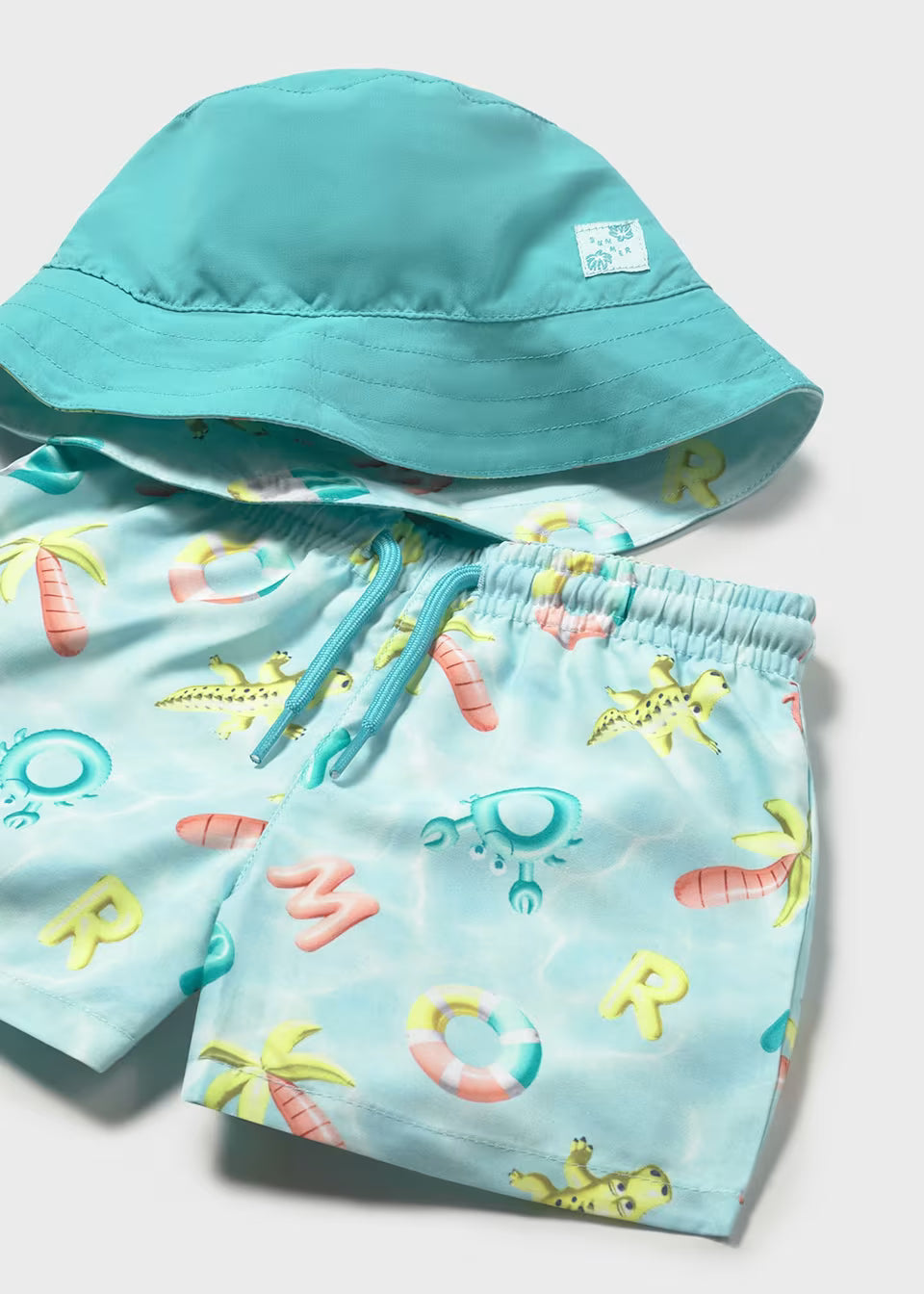 Conjunto bañador y gorro reversible protección solar bebé